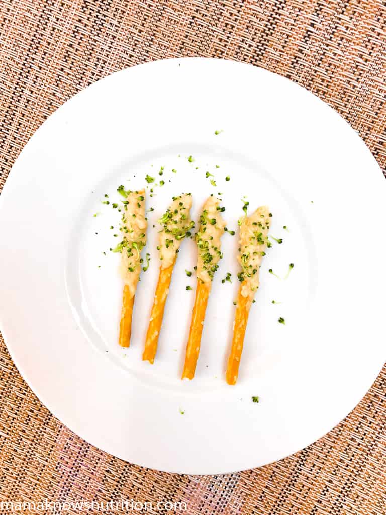 pretzels with hummus and sprinkles of broccoli