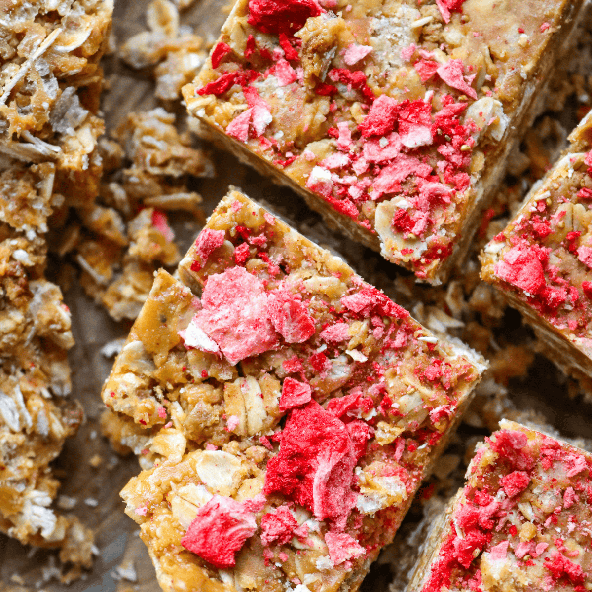 birds eye view of 4 slices of 5 ingredient nut butter bars with strawberry on top