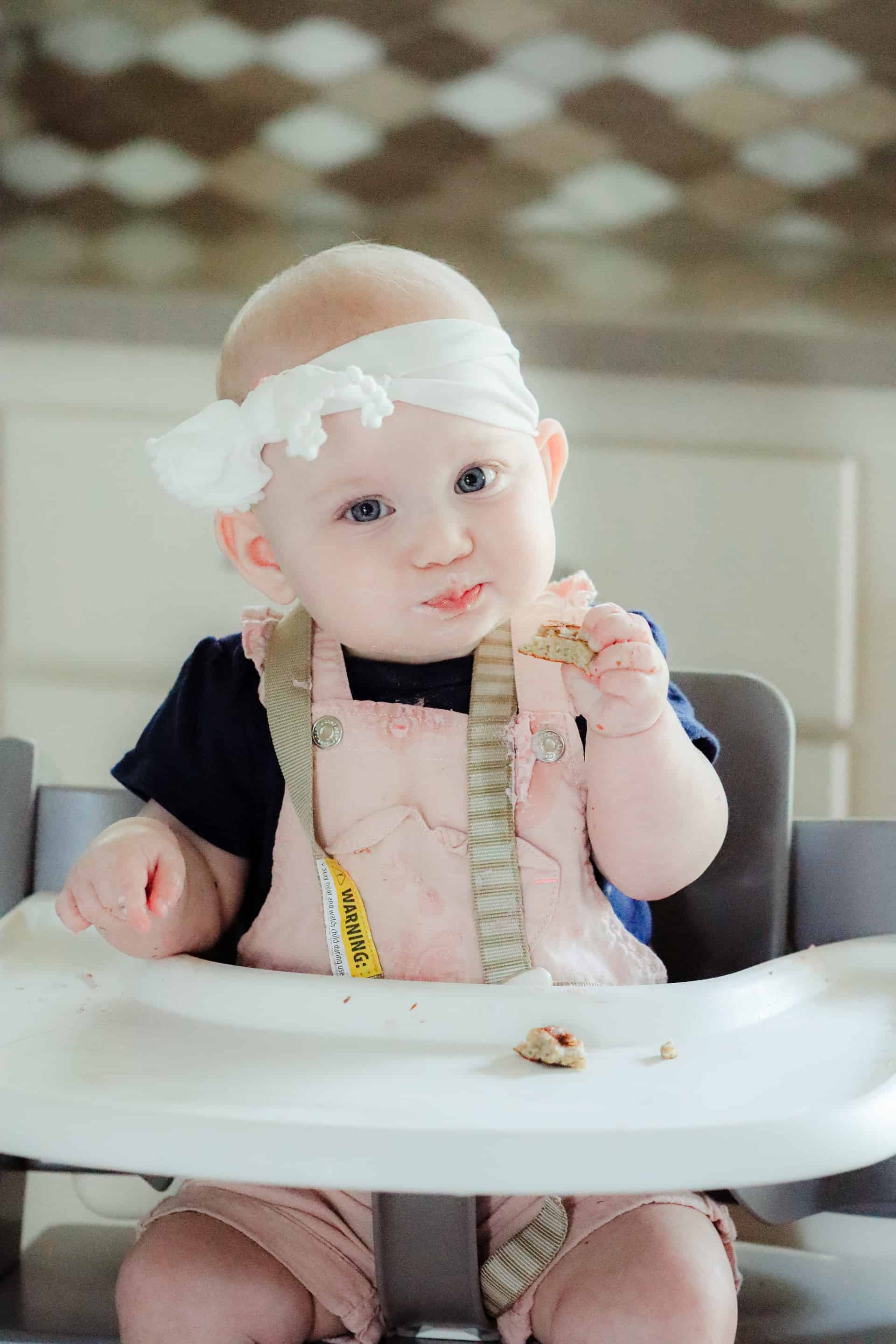 baby at high chair eating for simply solids