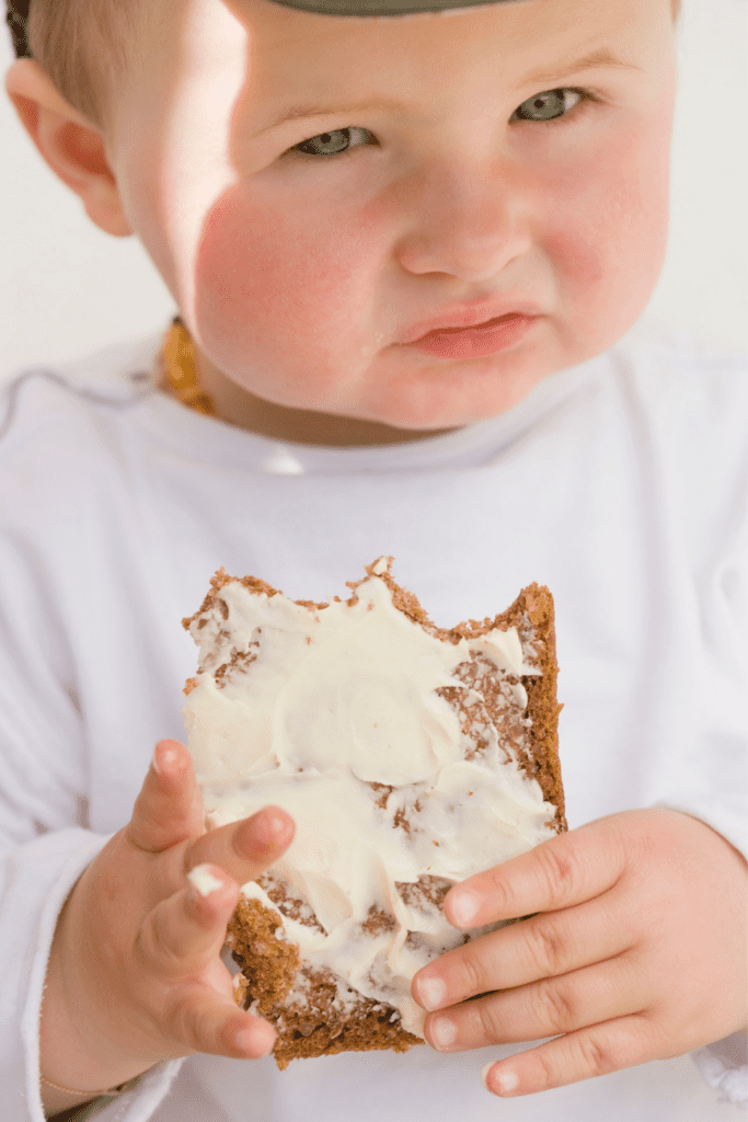 baby eating food with frosting sugar and toddlers