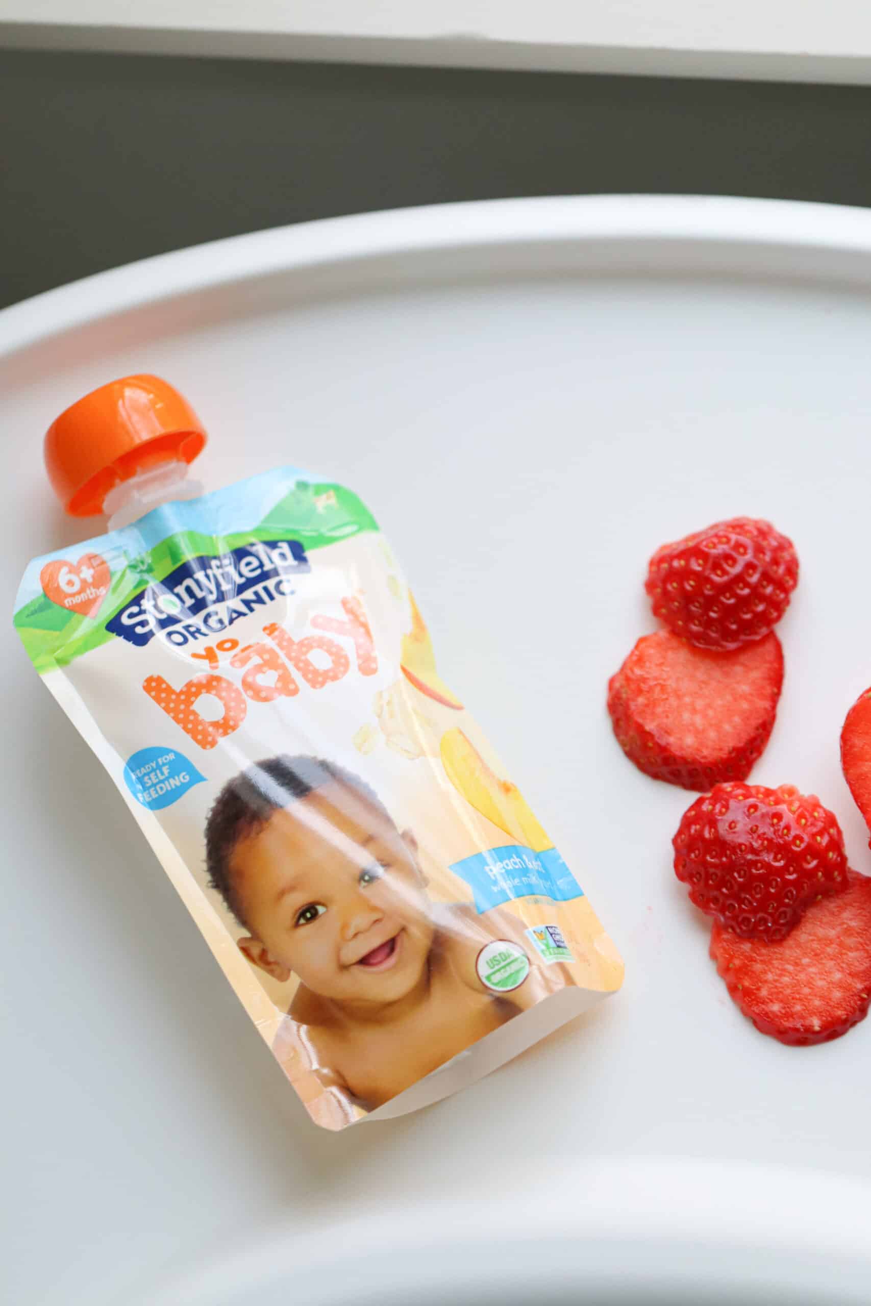 yo baby stonyfield yogurt pouch and sliced strawberries