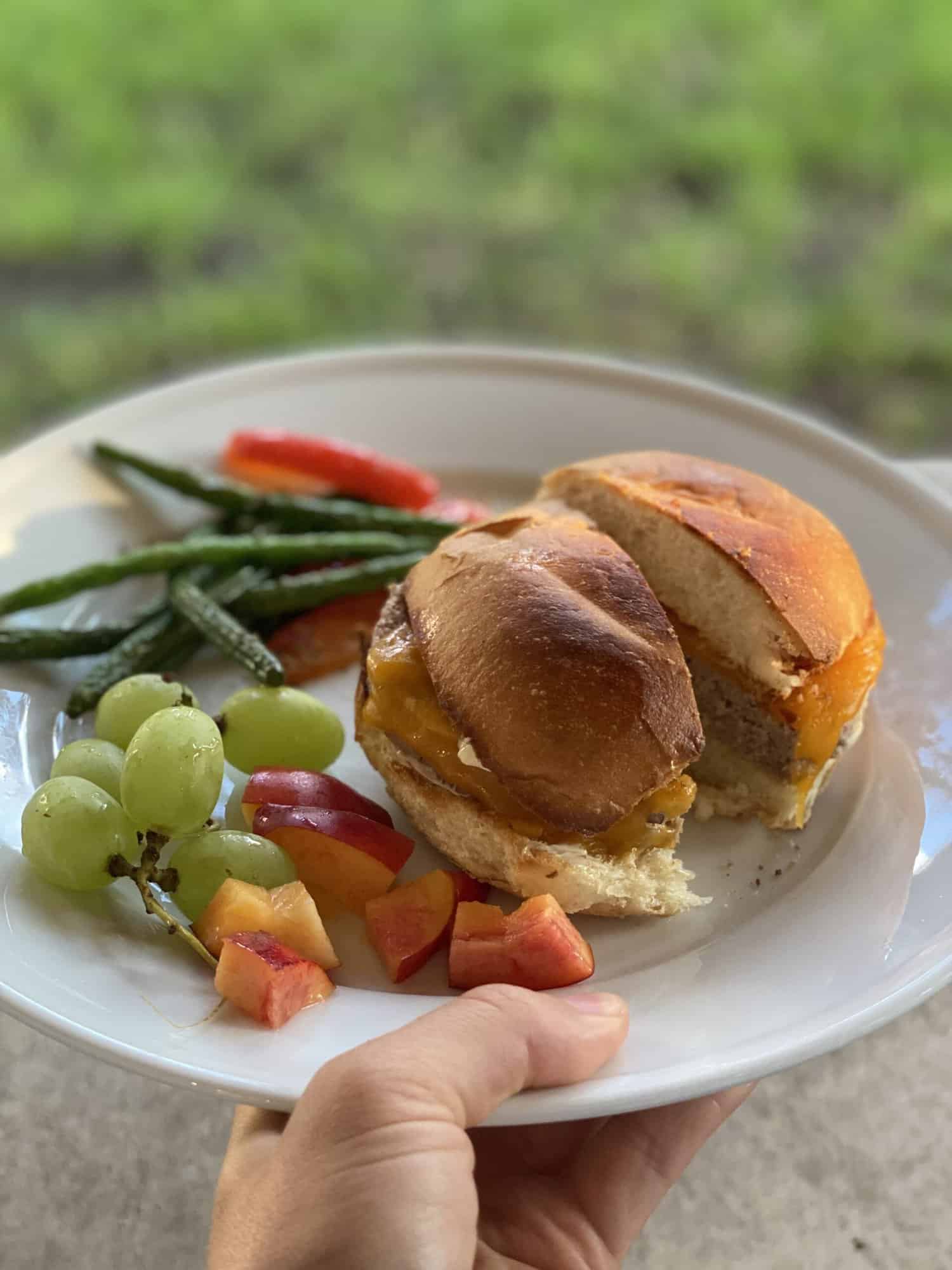 broiled turkey burger on whole wheat bun with cheddar cheese, diced peaches, green grapes, broiled green beans and red peppers