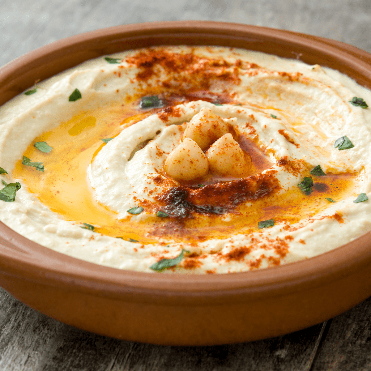 bowl of hummus with chickpeas and paprika