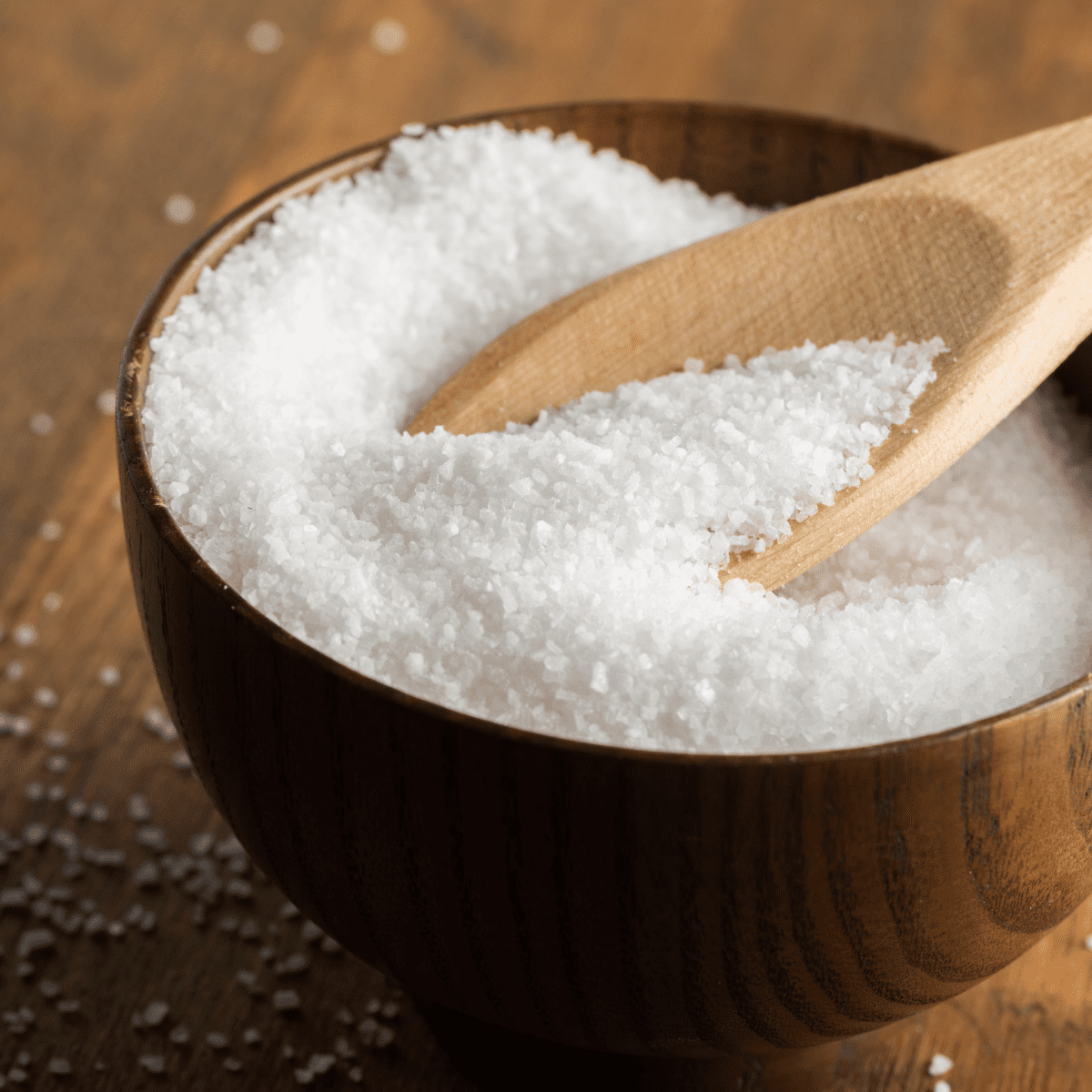 wooden bowl of sea salt with spoon