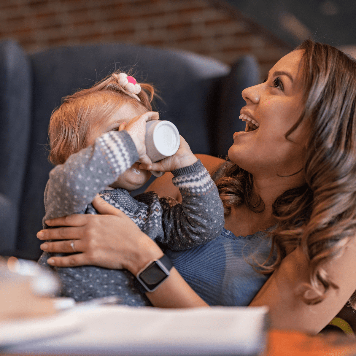 toddler drinks from open cup