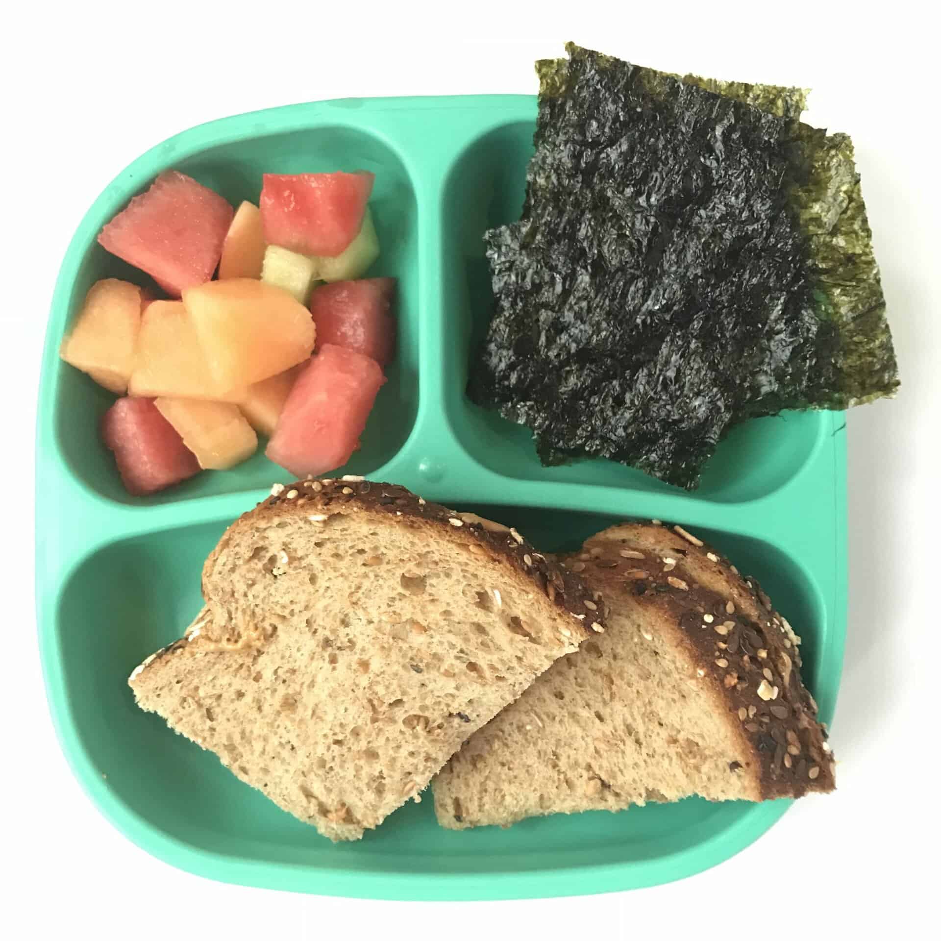 lunch with sandwich and fruit and seaweed chips