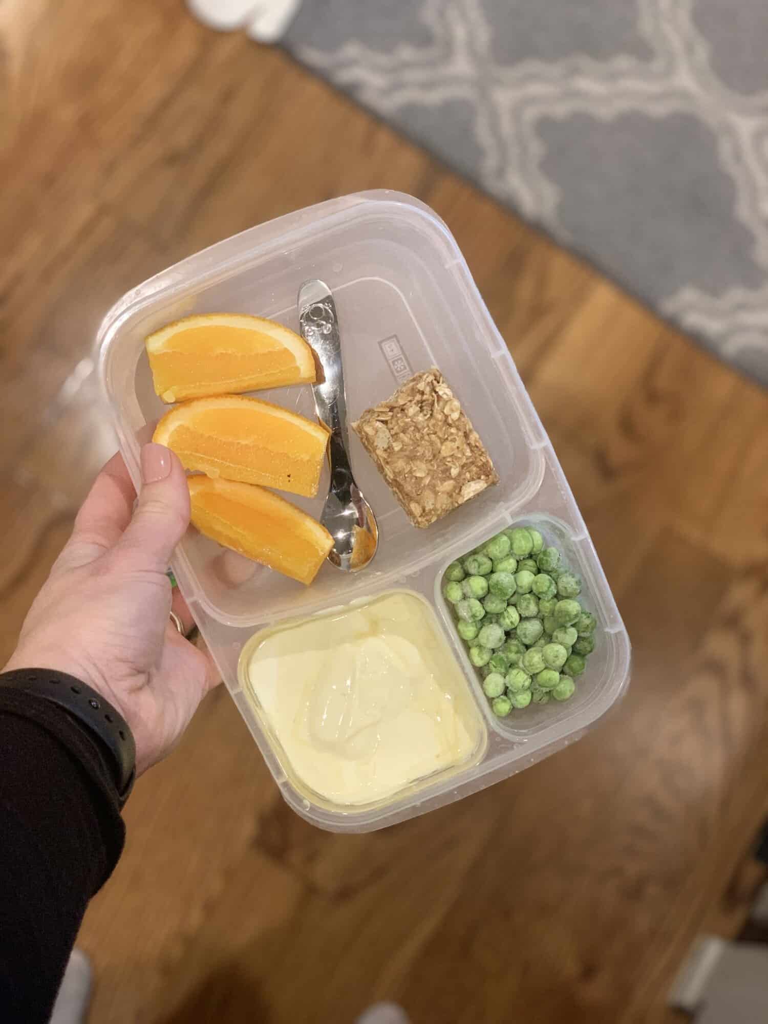 packed lunch with yogurt and oranges