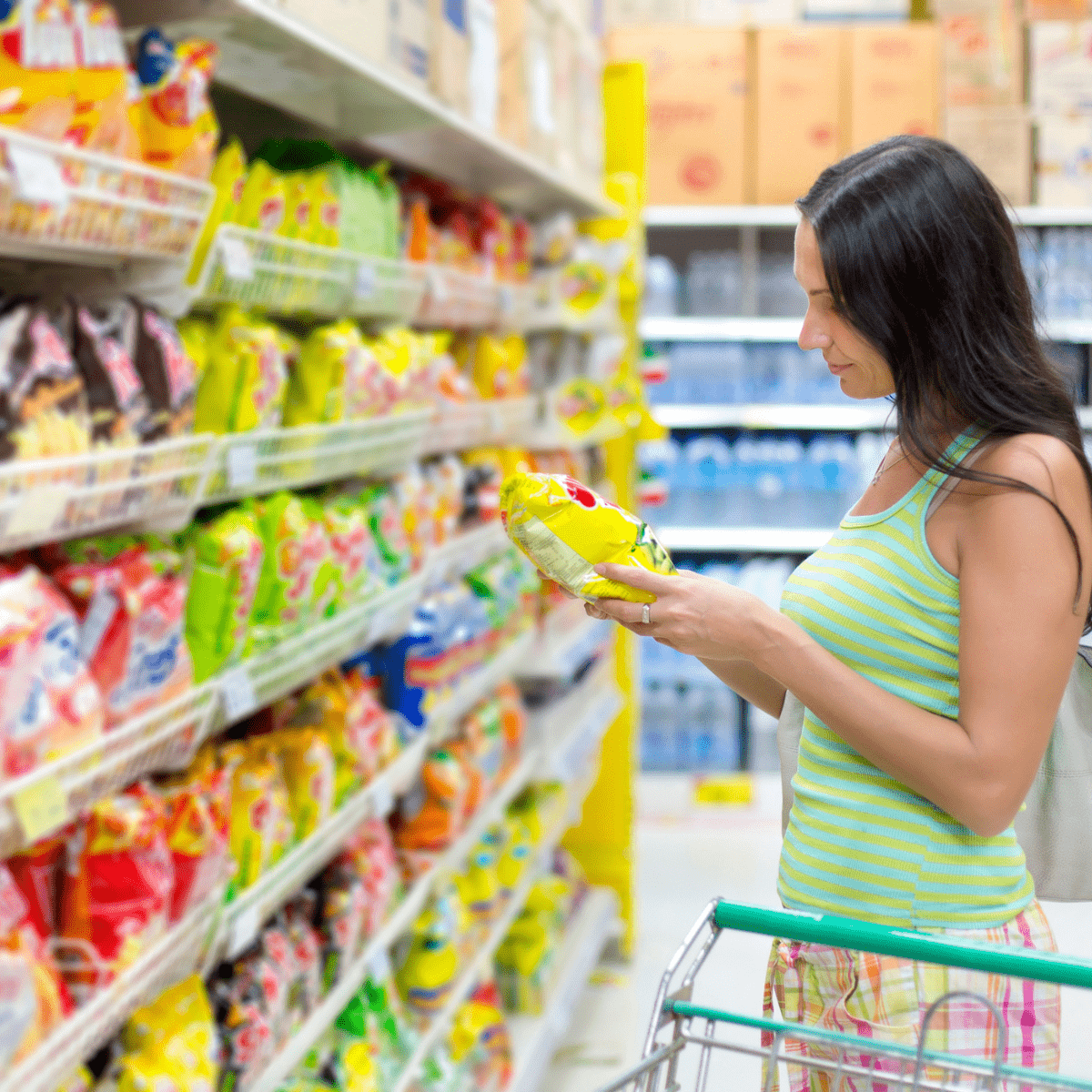 Woman shopping in snack aisle at grocery store