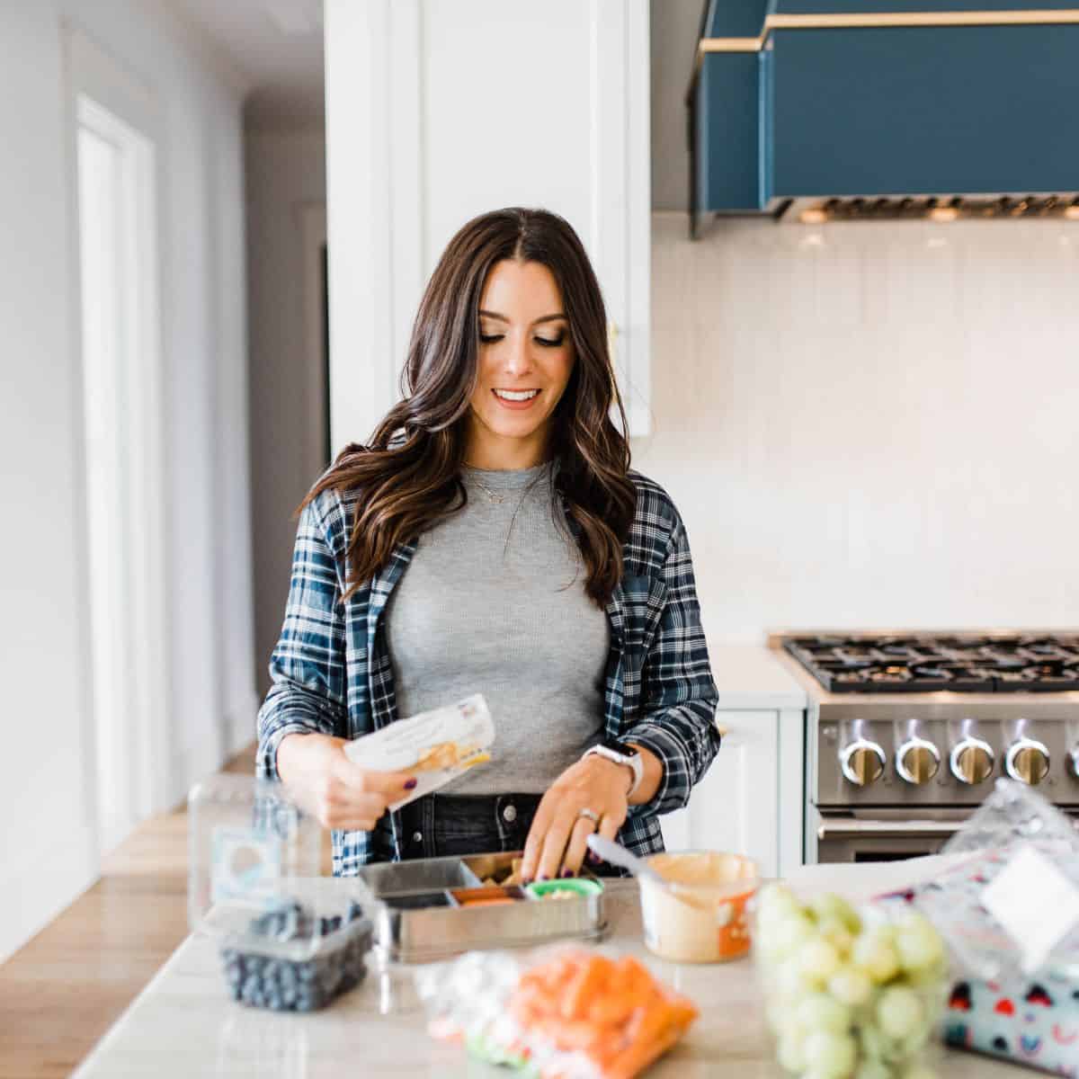 Kacie Barnes packing lunch at kitchen counter