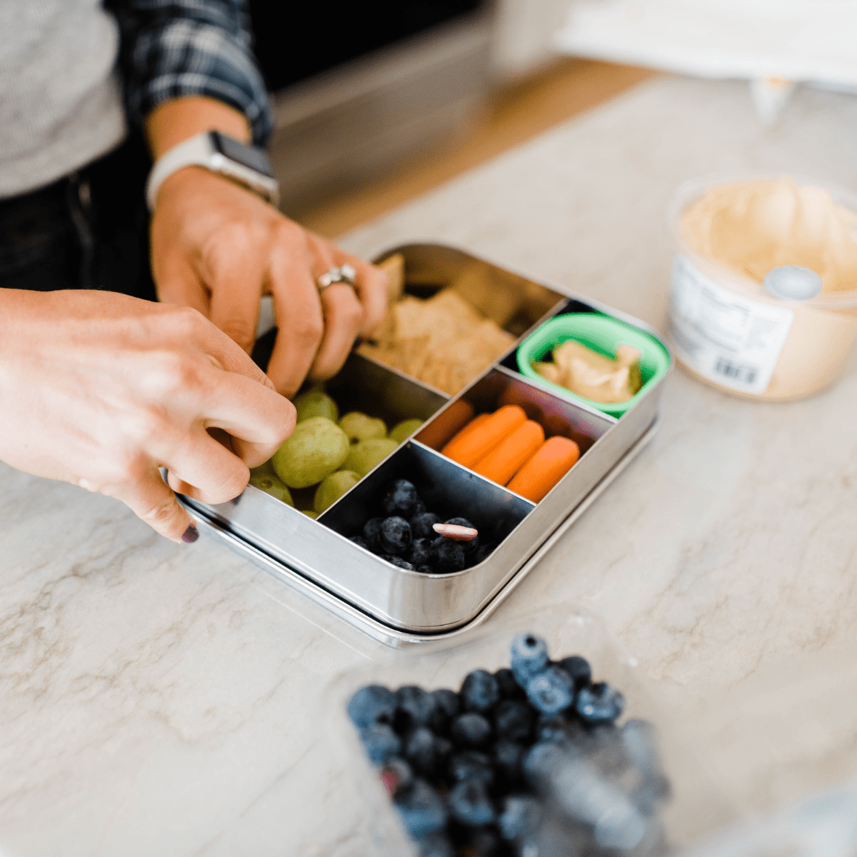 Hands packing a nut-free lunch