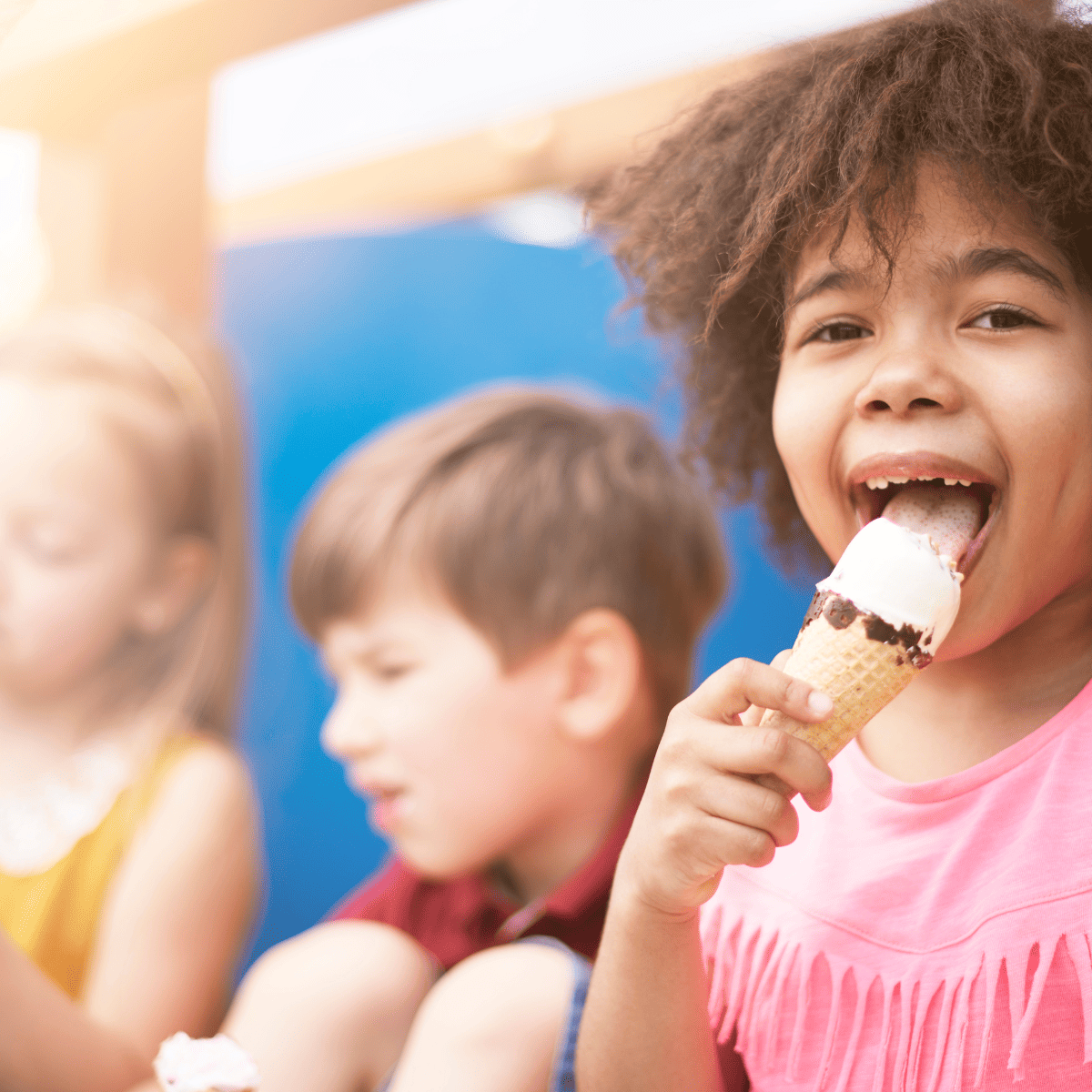 child licking ice cream cone