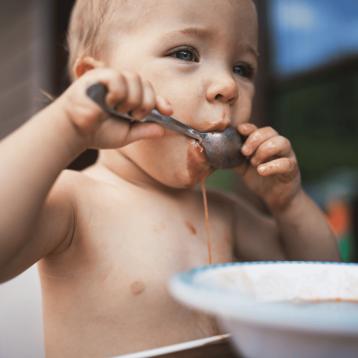 child eating noodles