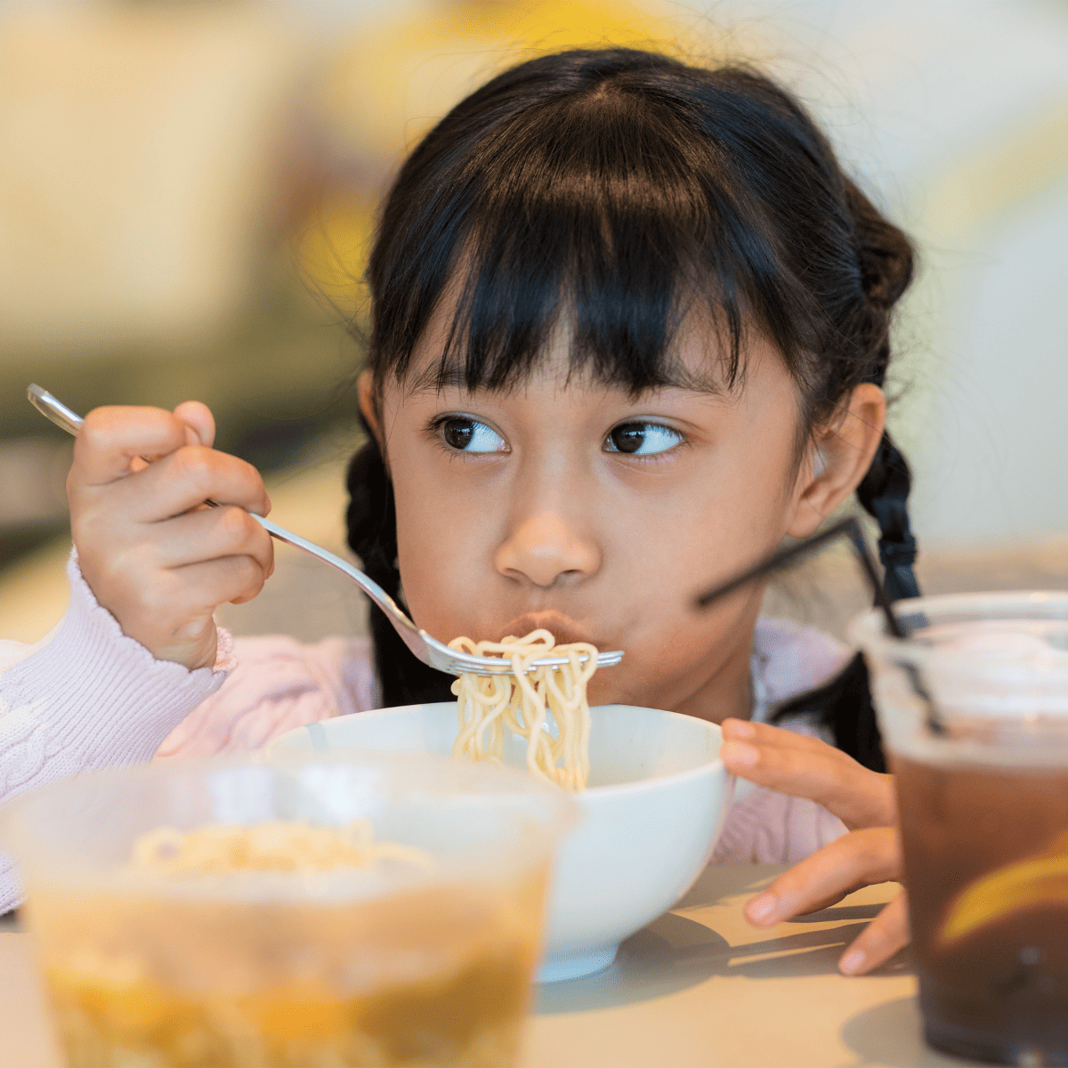 child eating soup