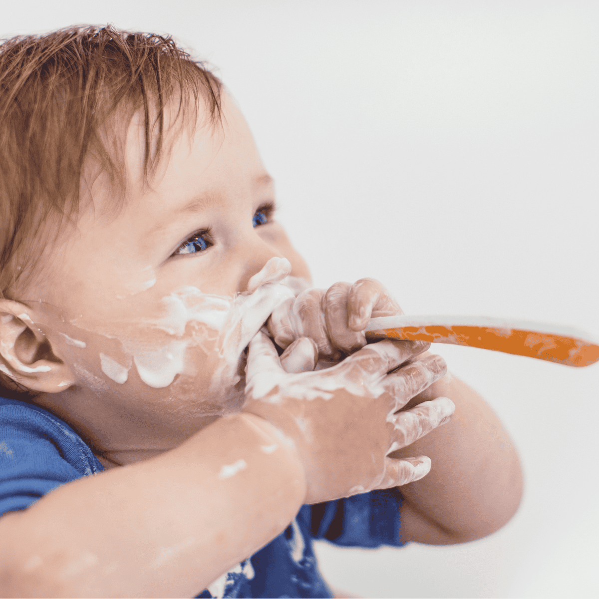 baby eating yogurt