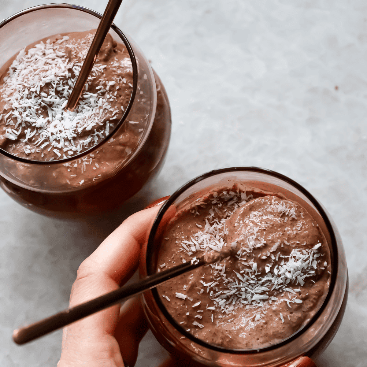 birds eye view of chocolate chia seed pudding topped with chia and coconut