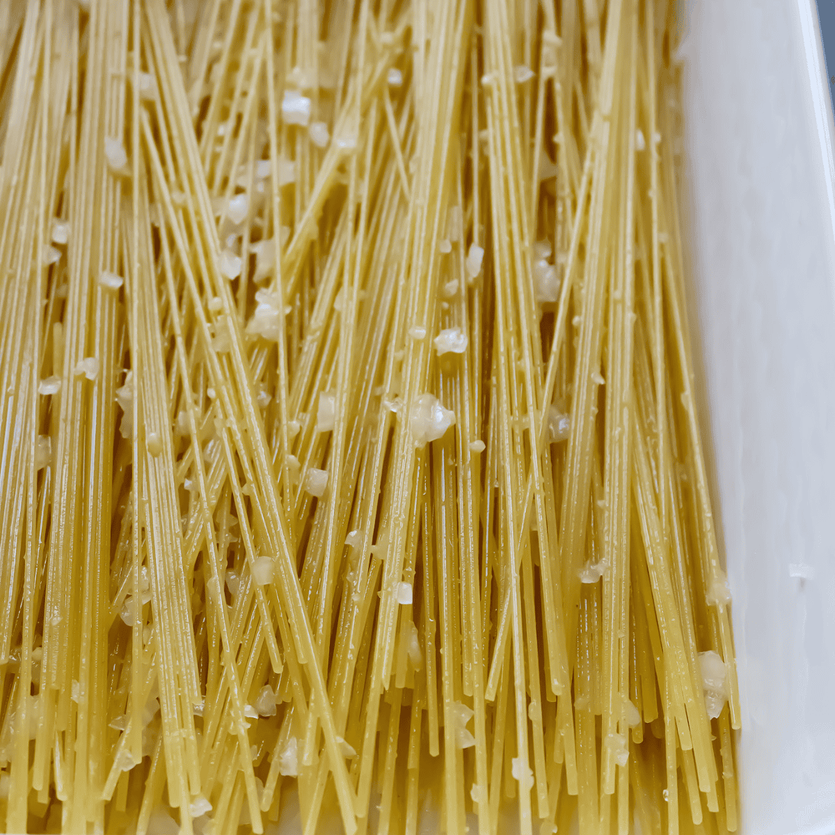 uncooked spaghetti noodles in 9x13 pan