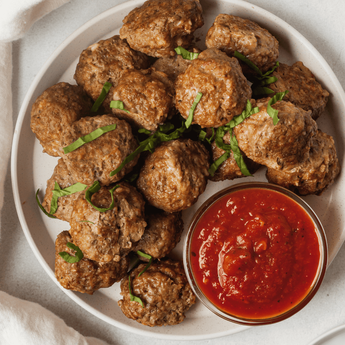 birds eye view of a plate of mini meatballs and sauce
