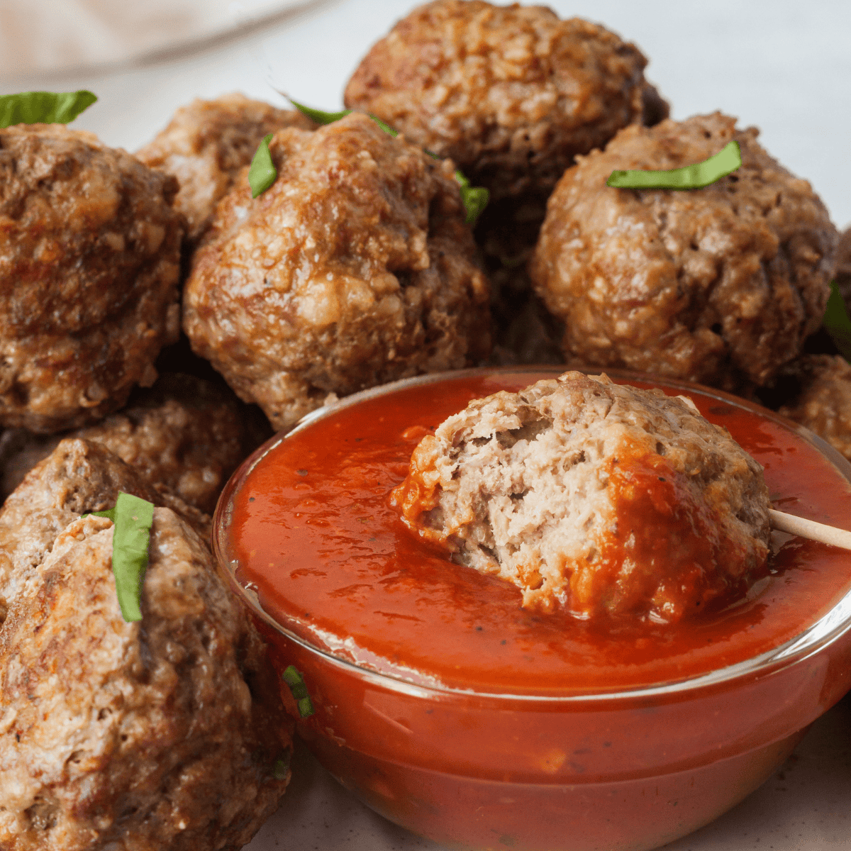 close up of mini meatballs dipped in sauce