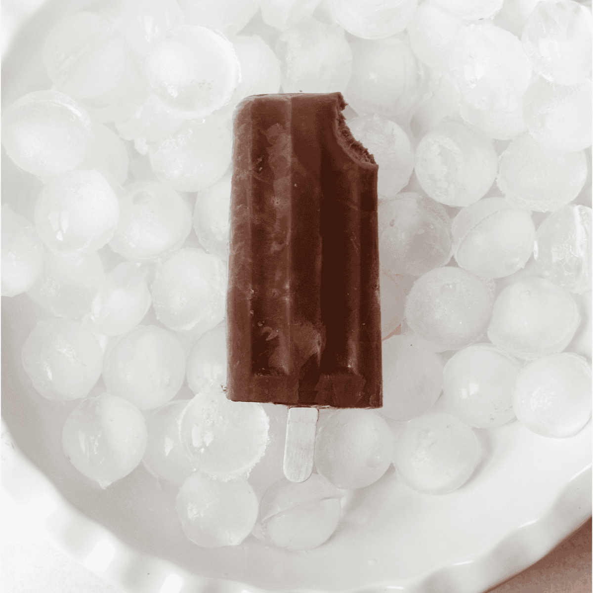 single chocolate banana popsicle on ice