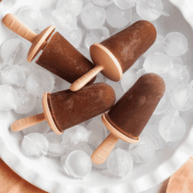 four banana popsicles sitting on ice
