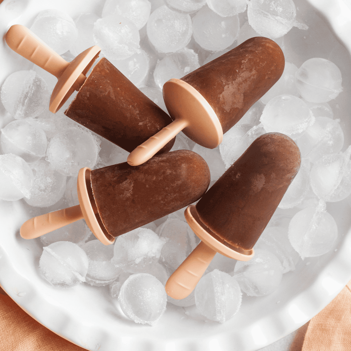 four popsicles sitting on ice