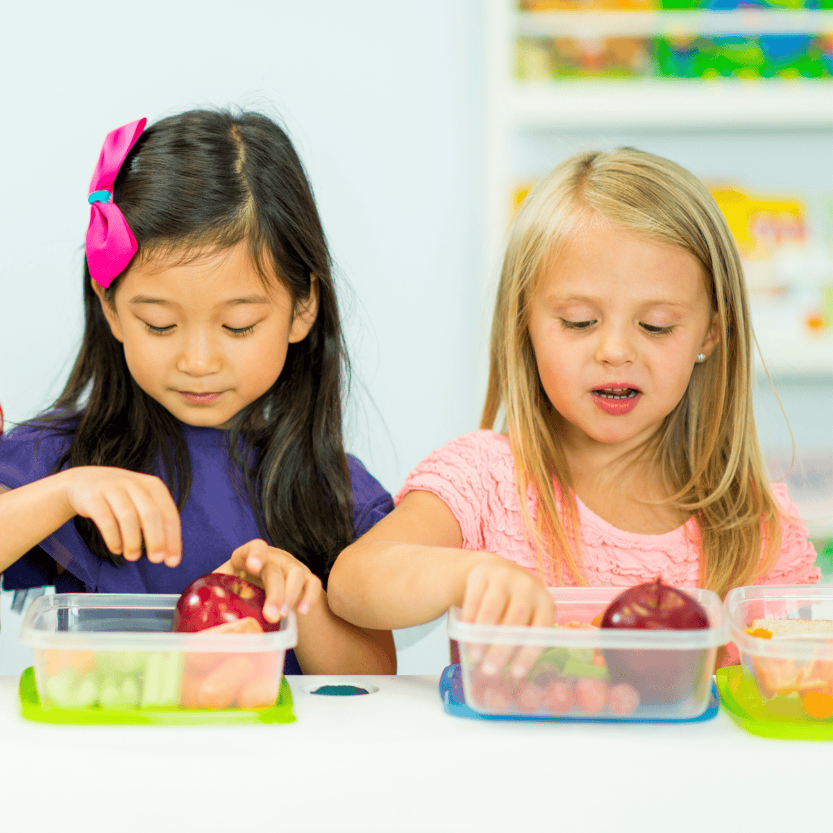 two girls snacking at school