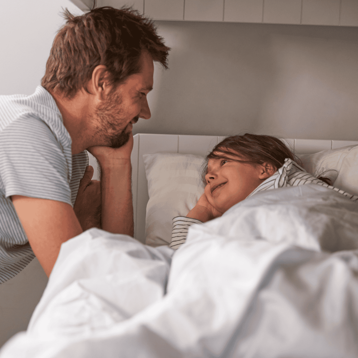 dad putting child down for bedtime